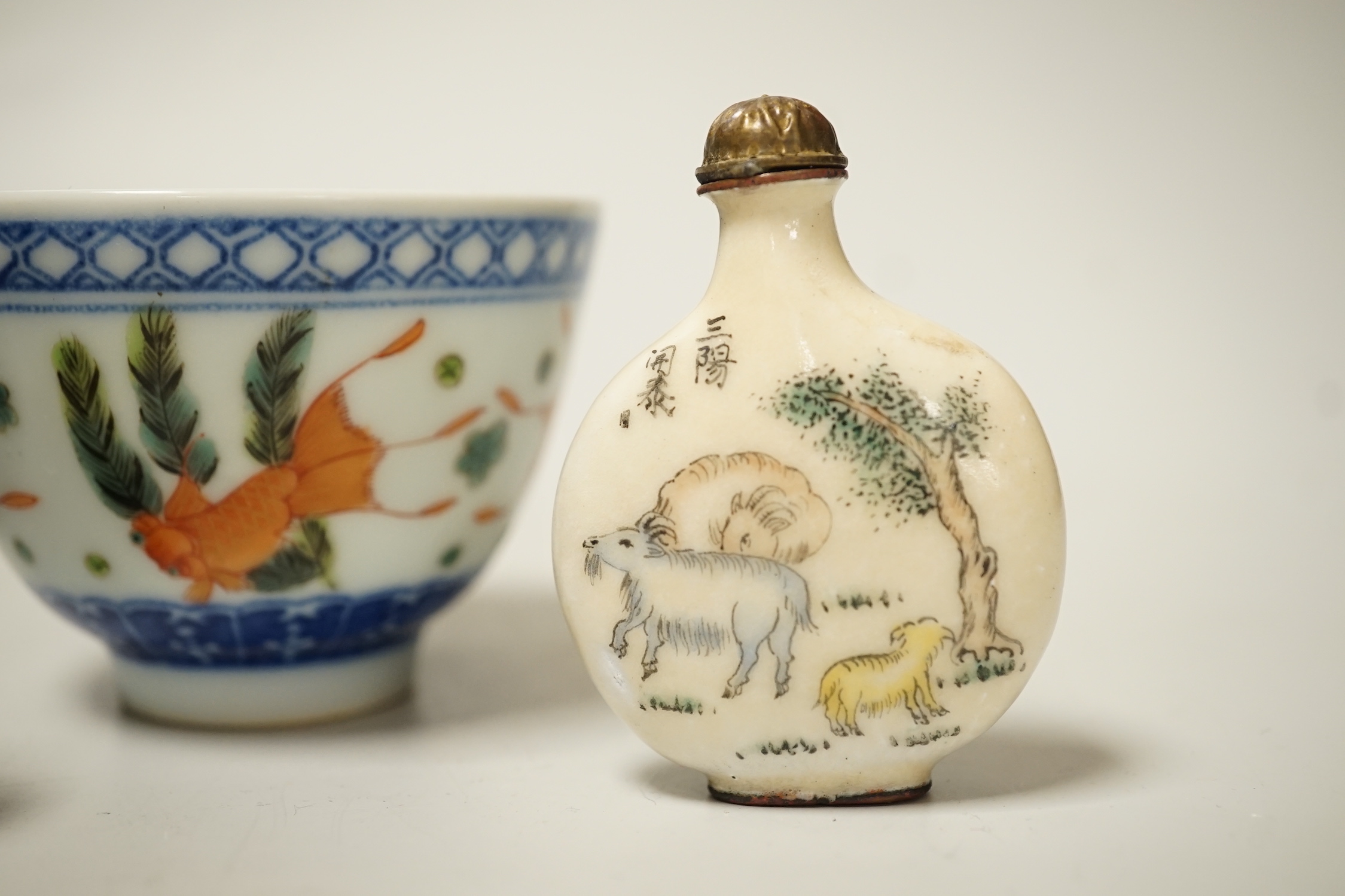 A 19th century Chinese blue and white bowl, an enamelled goldfish cup and two snuff bottles